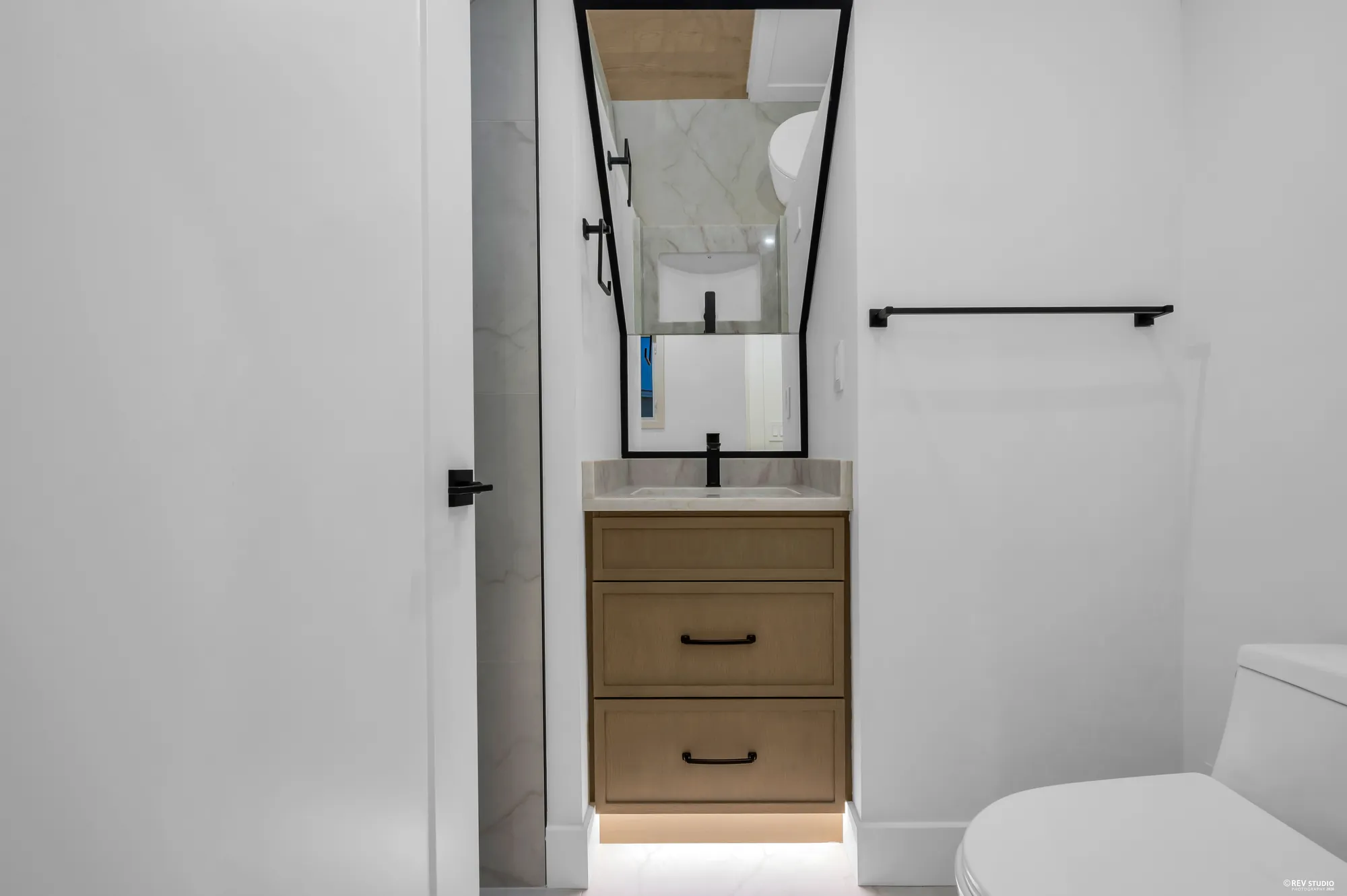 The top-floor bathroom with a shower and a slim vanity