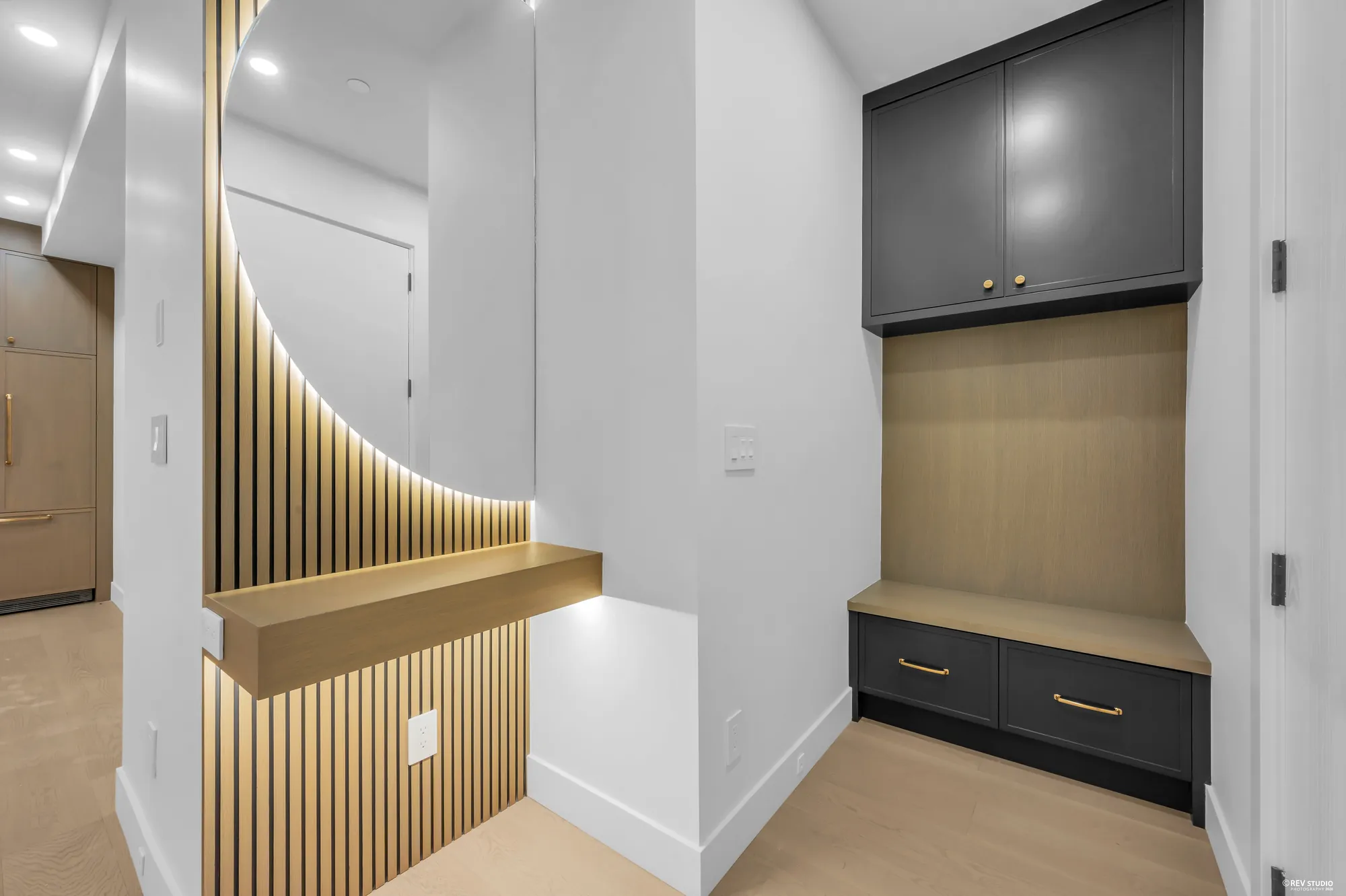 Fluted timber detail beside a built-in bench and cabinet