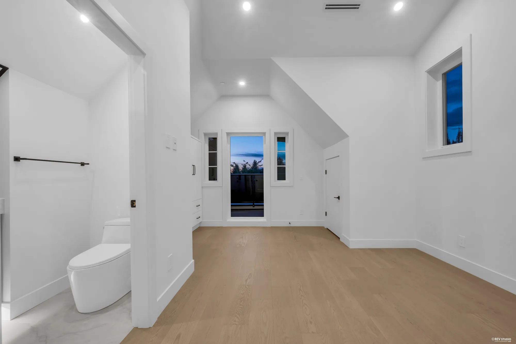 The hall on the bedroom floor with a window at the end